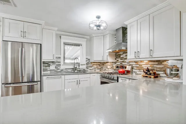 a kitchen with stainless steel appliances cabinets and a window