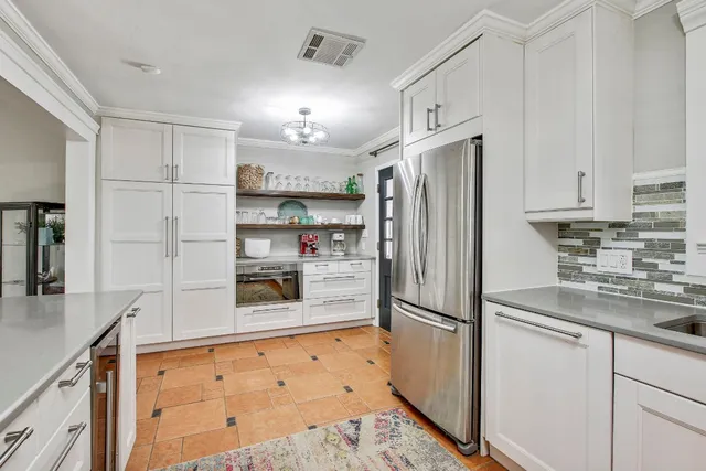 a kitchen with stainless steel appliances granite countertop a sink stove and cabinets