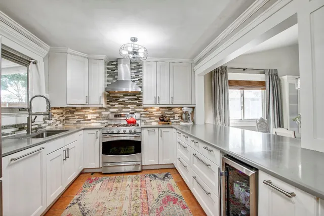 a kitchen with stainless steel appliances a stove sink and cabinets
