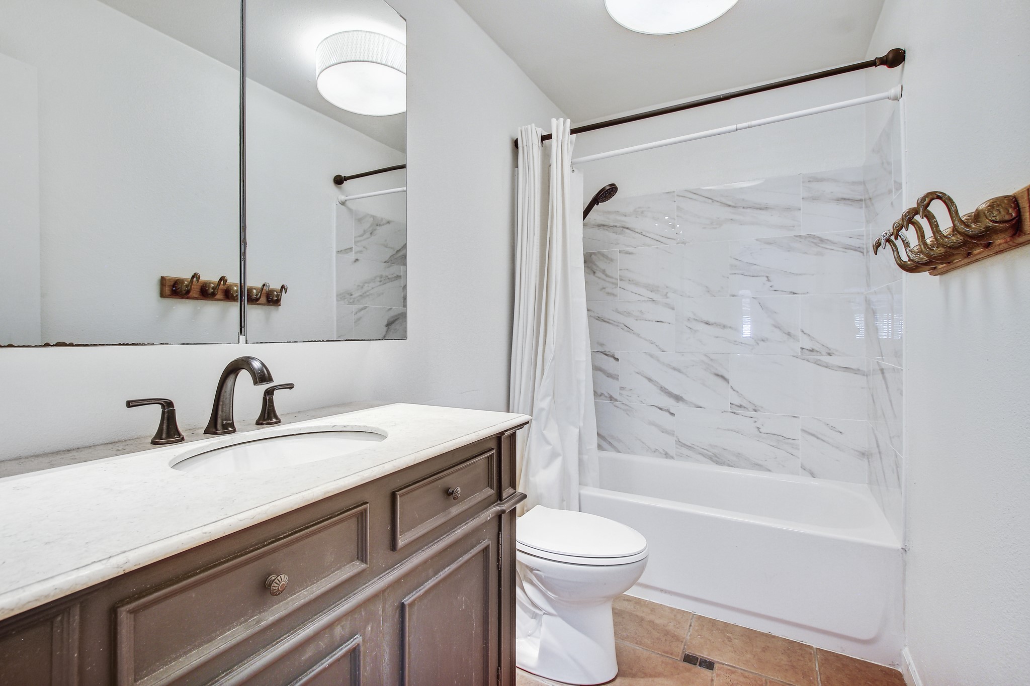 7741 Manassas Drive Austin, TX 78745 - Photo 29 of 39 Full bathroom with vanity, shower / tub combo, and light tile patterned floors