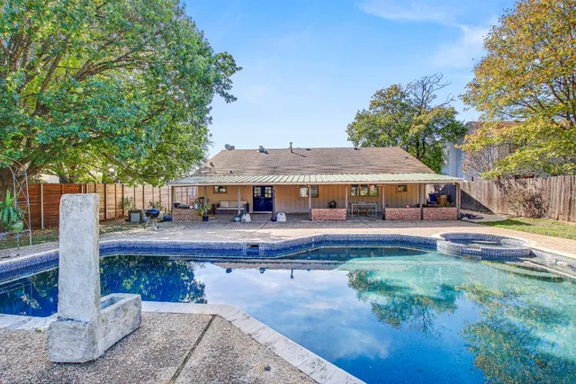 a garden with trees in front of it