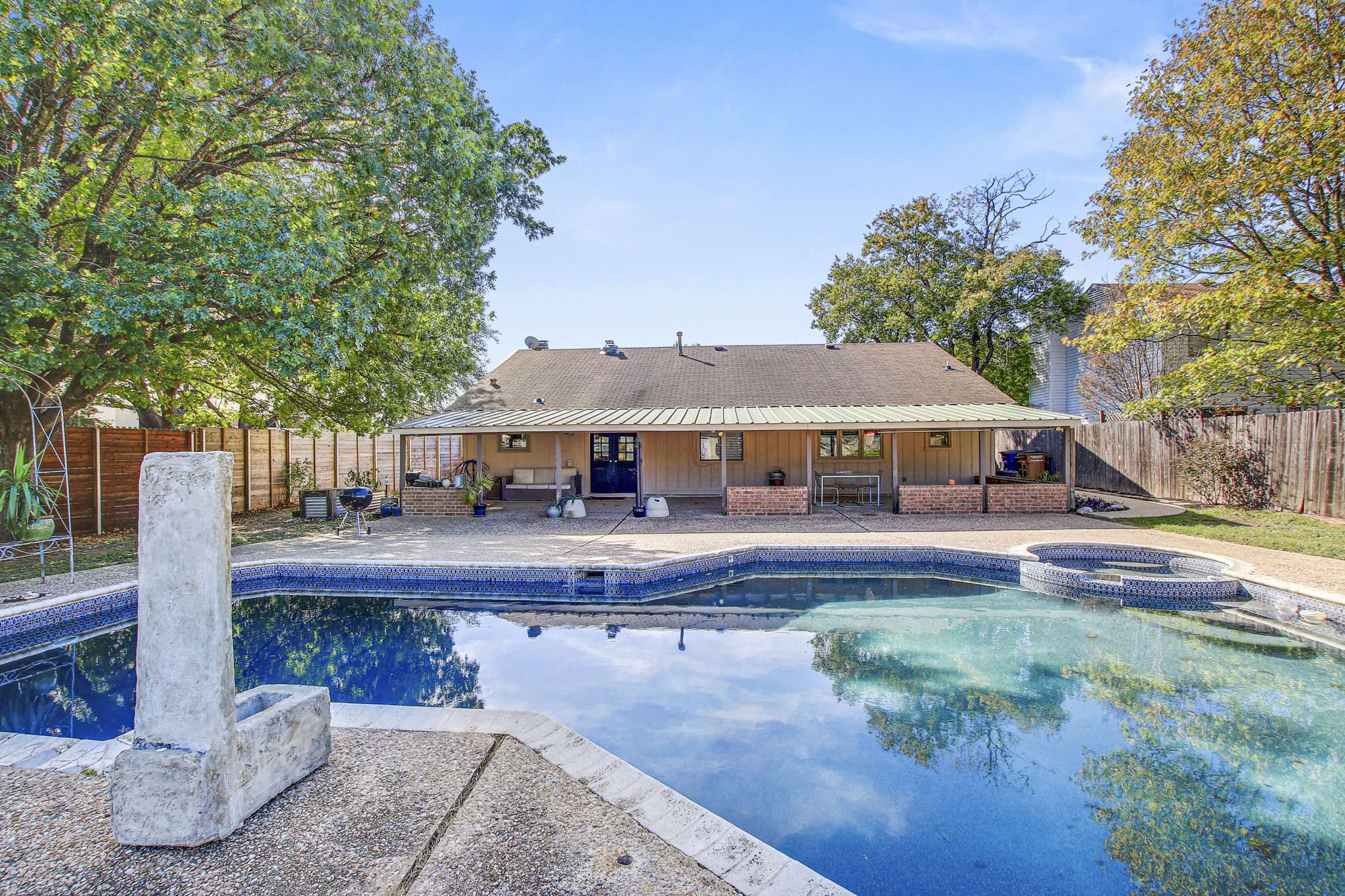 7741 Manassas Drive Austin, TX 78745 - Photo 32 of 39 View of swimming pool with a patio, a fenced backyard, and a pool with connected hot tub