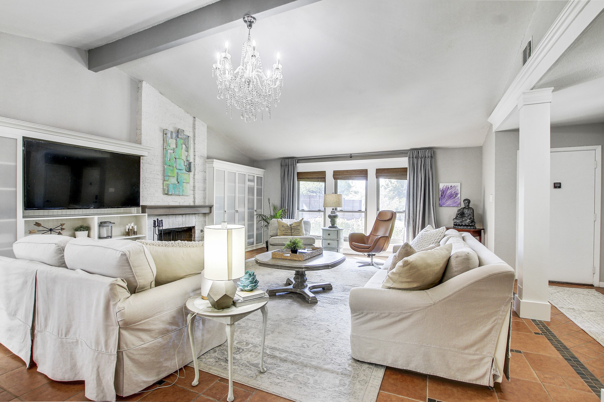 7741 Manassas Drive Austin, TX 78745 - Photo 5 of 39 Living area featuring inlaid floor details, a chandelier, and a fireplace