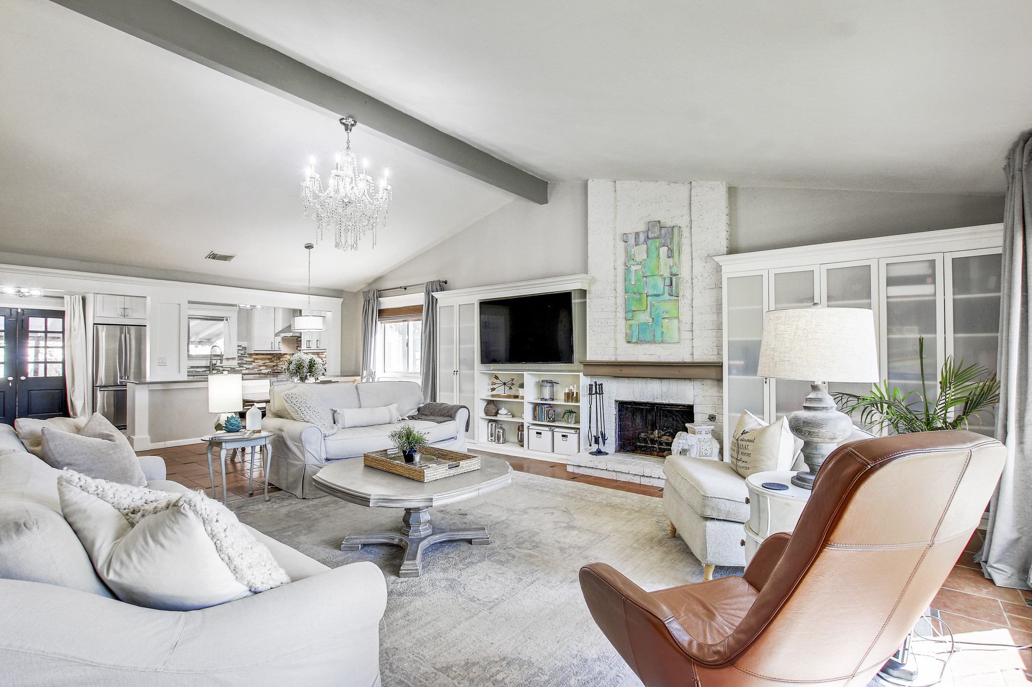 7741 Manassas Drive Austin, TX 78745 - Photo 6 of 39 Living area with a fireplace and a chandelier