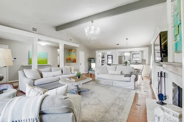 a living room with furniture fireplace and a flat screen tv