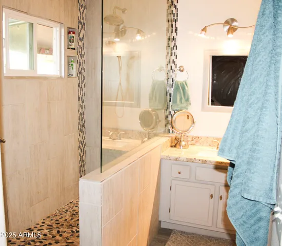 a bathroom with a sink a vanity and a mirror
