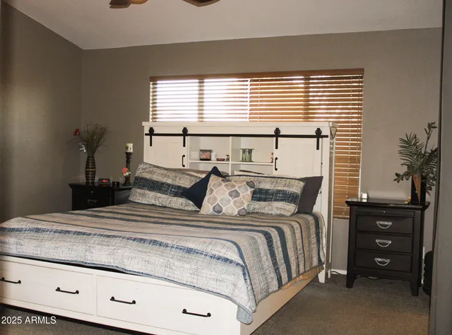 a bedroom with a bed and a window