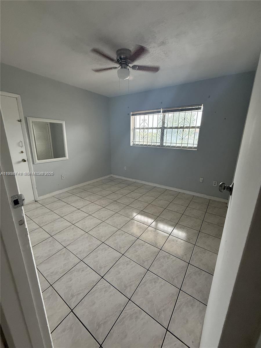 7505 Southwest 82nd Street, Unit 314 Miami, FL 33143 - Photo 6 of 9 a view of an empty room and window