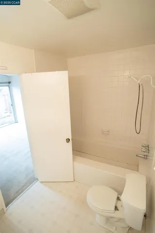 a bathroom with a shower and a toilet