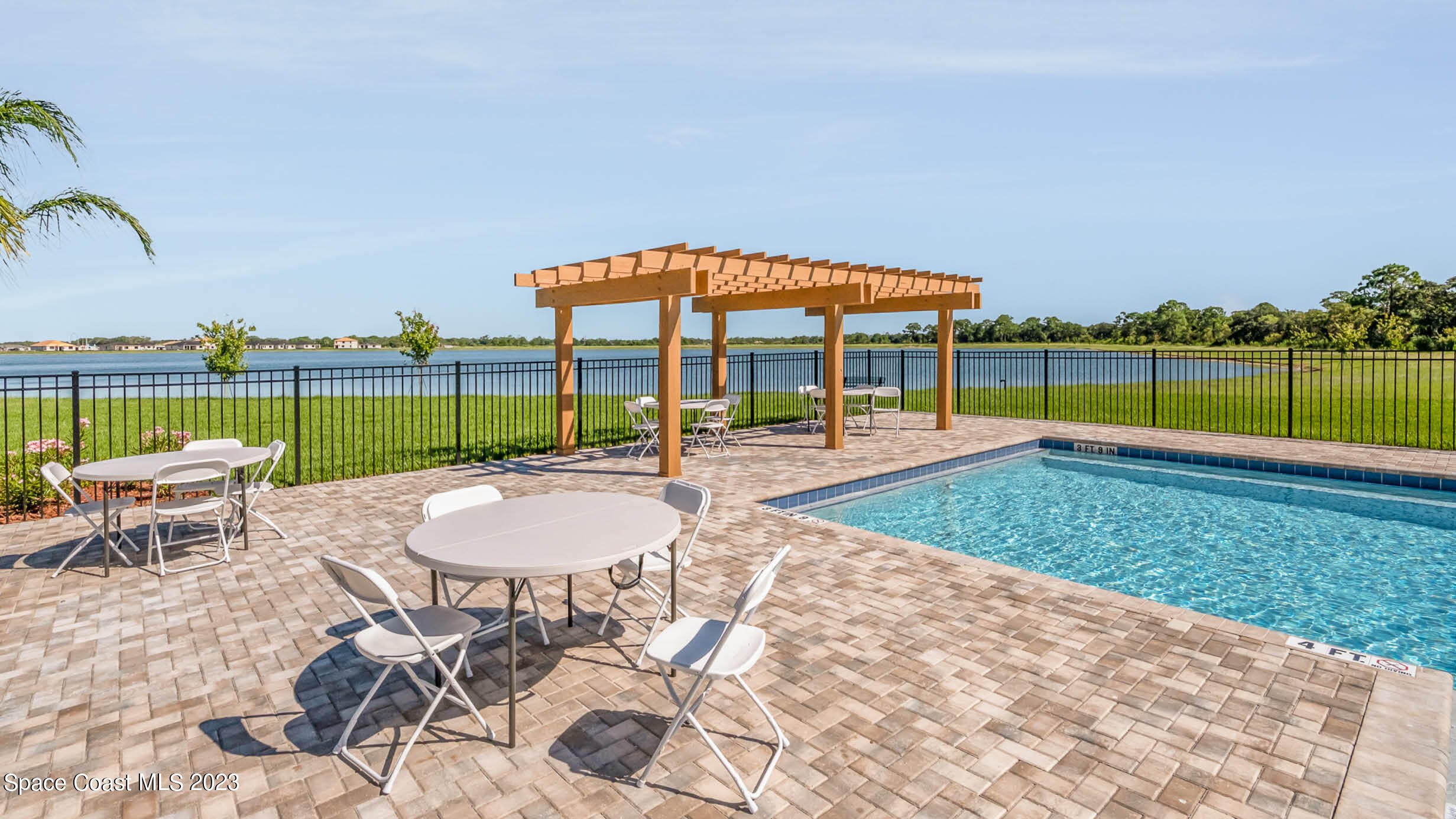 2054 Farmhouse Road Palm Bay, FL 32909 - Photo 26 of 31 a swimming pool with outdoor seating and yard