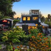 an aerial view of a house with a yard and balcony