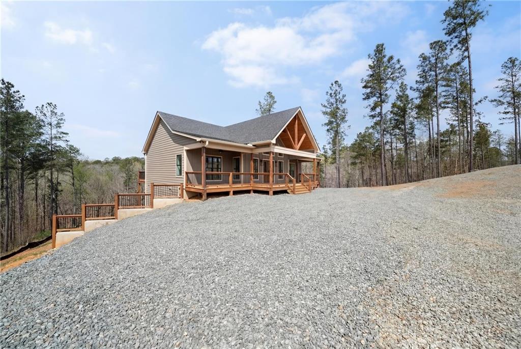 2956 Blalock Mountain Road Talking Rock, GA 30175 - Photo 42 of 65 a front view of a house with a yard and balcony