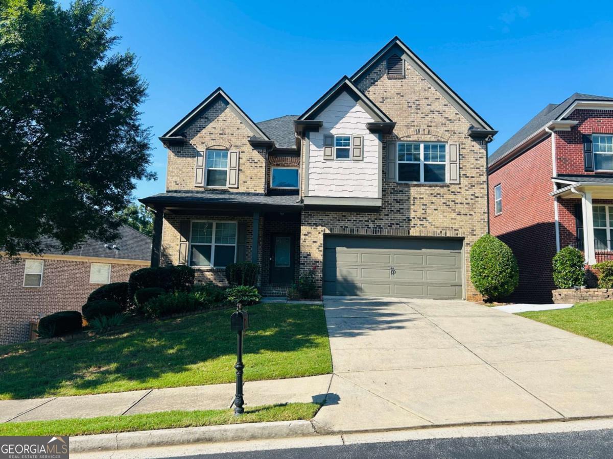 a front view of a house with a yard and garage