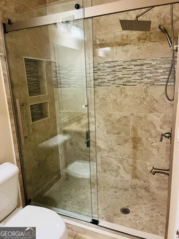 a bathroom with a shower and toilet