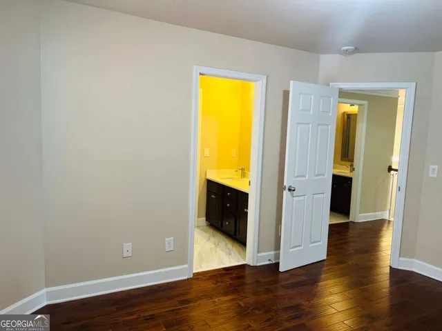 an empty room with wooden floor and a window