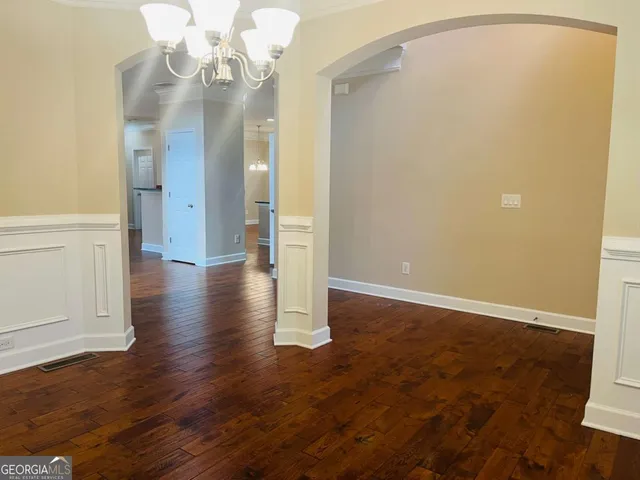 an empty room with wooden floor