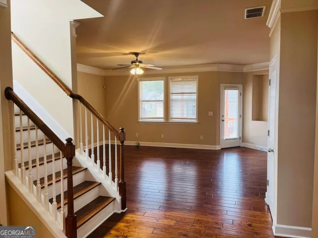 a view of an entryway with wooden floor and staircase