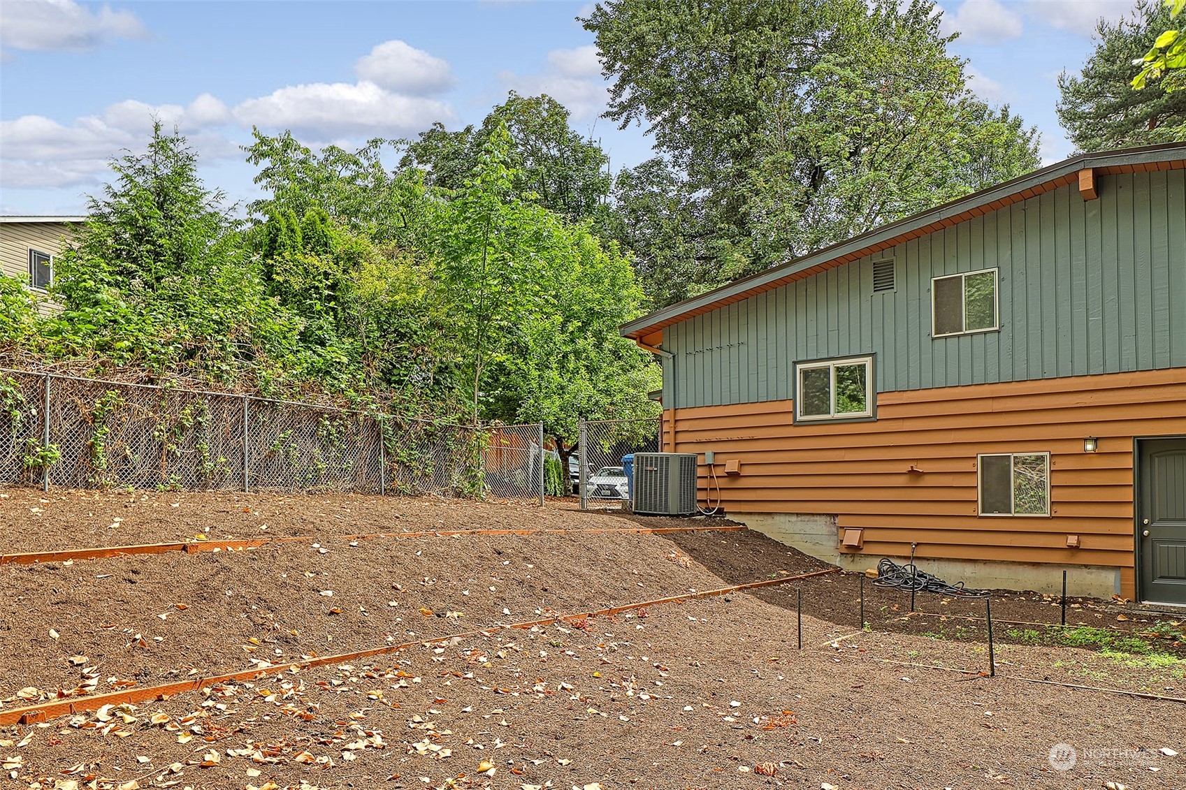 11629 53rd Avenue South Seattle, WA 98178 - Photo 26 of 26 a backyard of a house with large trees and outdoor seating