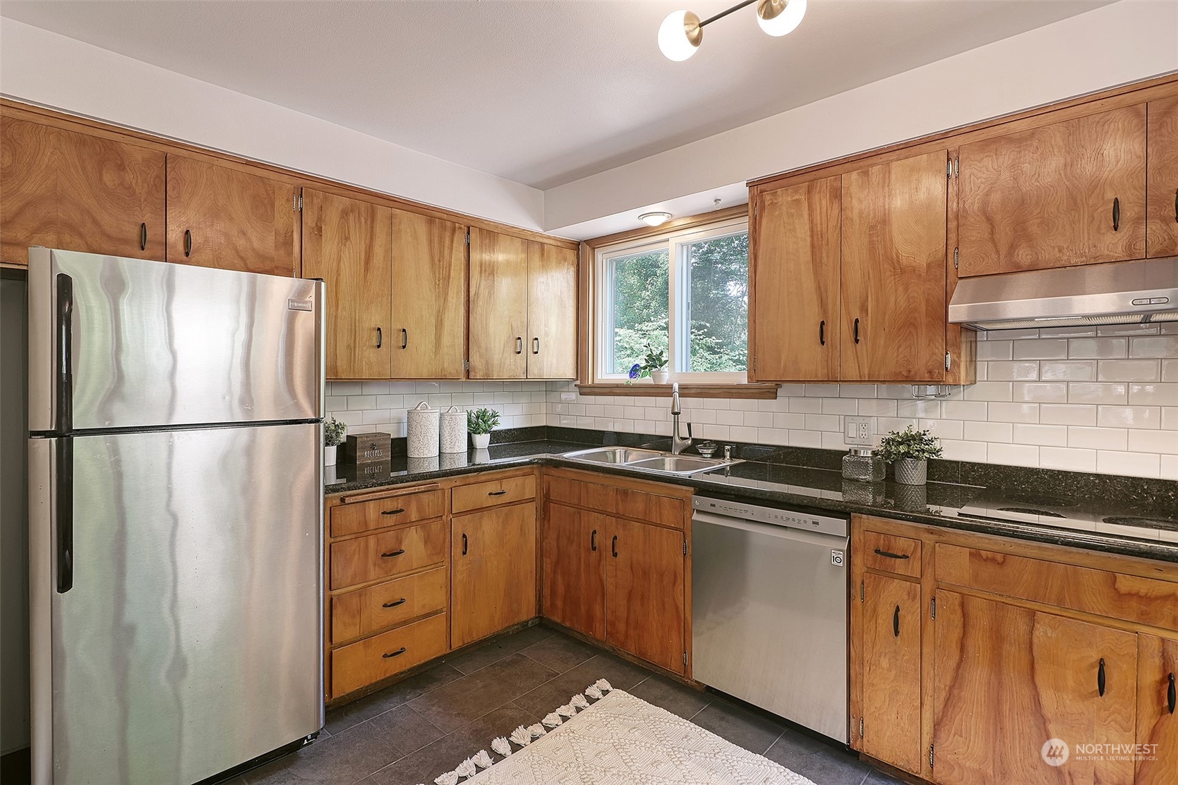 11629 53rd Avenue South Seattle, WA 98178 - Photo 8 of 26 a kitchen with stainless steel appliances granite countertop a refrigerator sink and cabinets