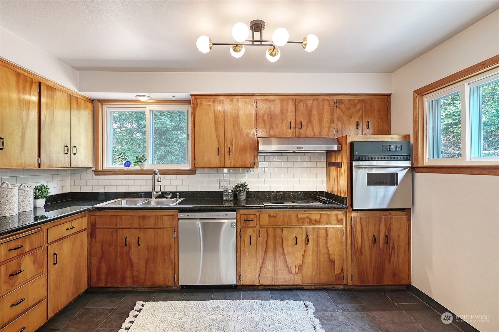 11629 53rd Avenue South Seattle, WA 98178 - Photo 9 of 26 a kitchen with granite countertop a sink a counter space cabinets and appliances