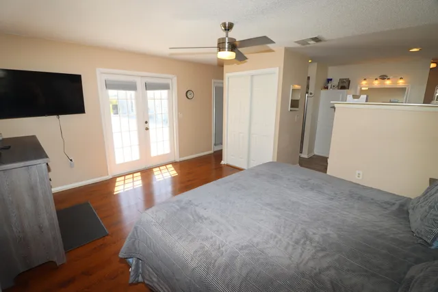 a view of a livingroom with furniture wooden floor and a flat screen tv