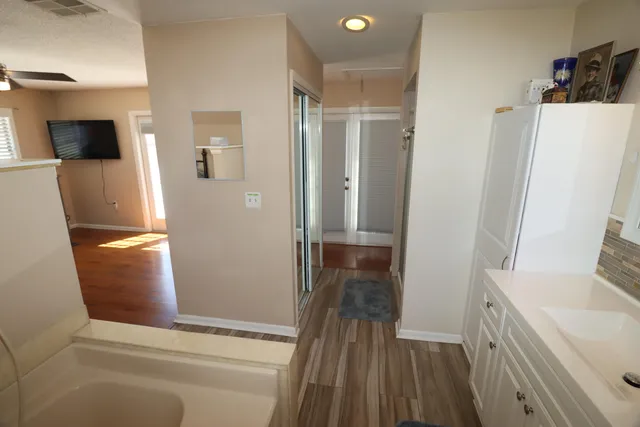 a bathroom with a sink a mirror and a window