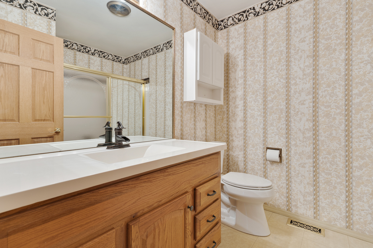 375 Pinetree Lane, Unit D1 Schaumburg, IL 60193 - Photo 16 of 25 a bathroom with a granite countertop sink toilet and shower