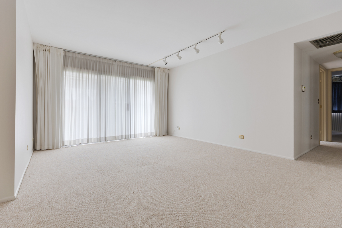 375 Pinetree Lane, Unit D1 Schaumburg, IL 60193 - Photo 2 of 25 a view of an empty room with a window