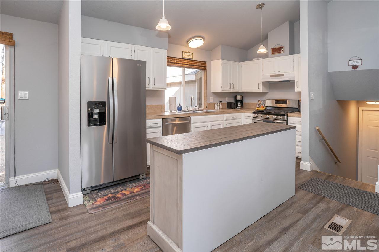 3675 Renee Way Reno, NV 89503 - Photo 15 of 40 a kitchen with stainless steel appliances a refrigerator sink and cabinets