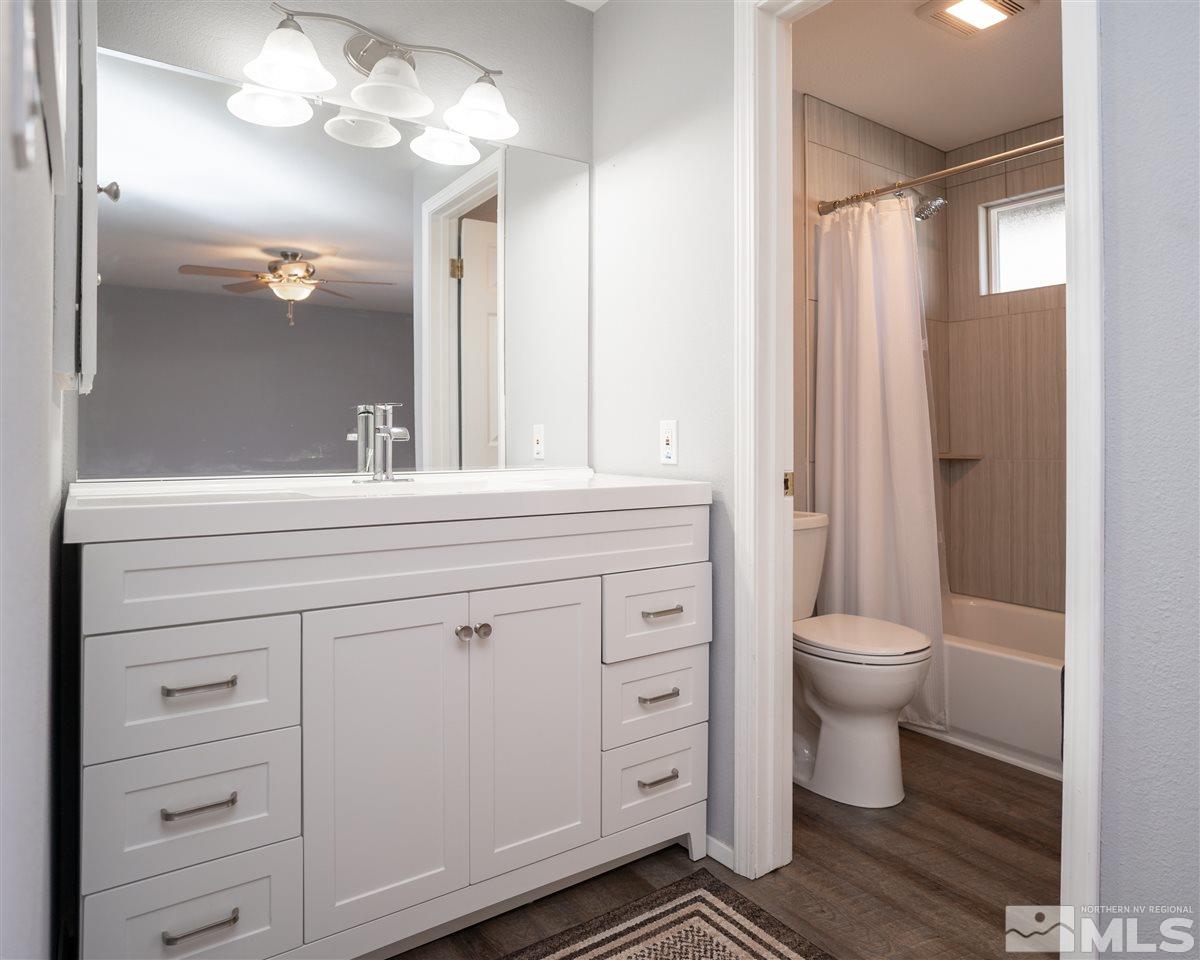 3675 Renee Way Reno, NV 89503 - Photo 23 of 40 a bathroom with a sink a toilet and a mirror