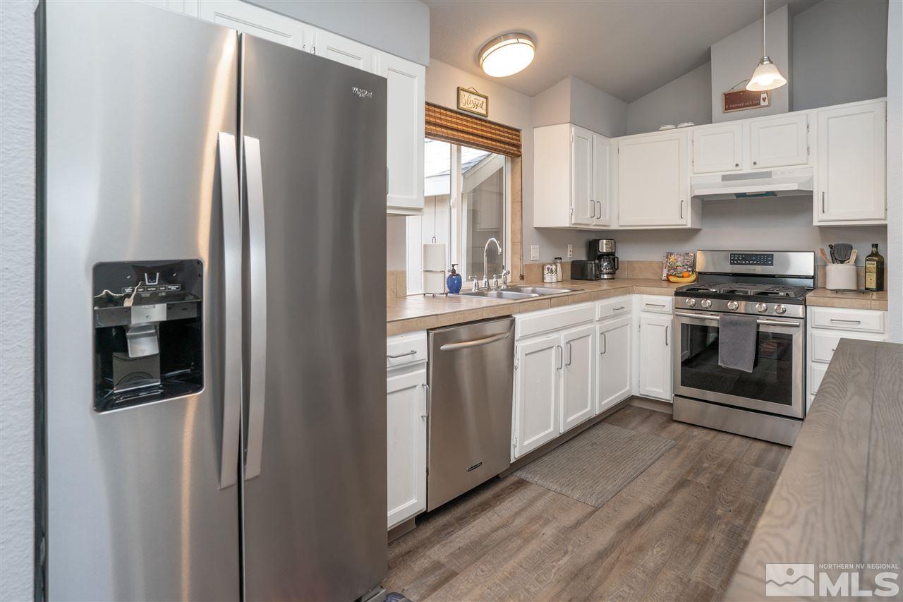 3675 Renee Way Reno, NV 89503 - Photo 5 of 40 a kitchen with cabinets stainless steel appliances and window