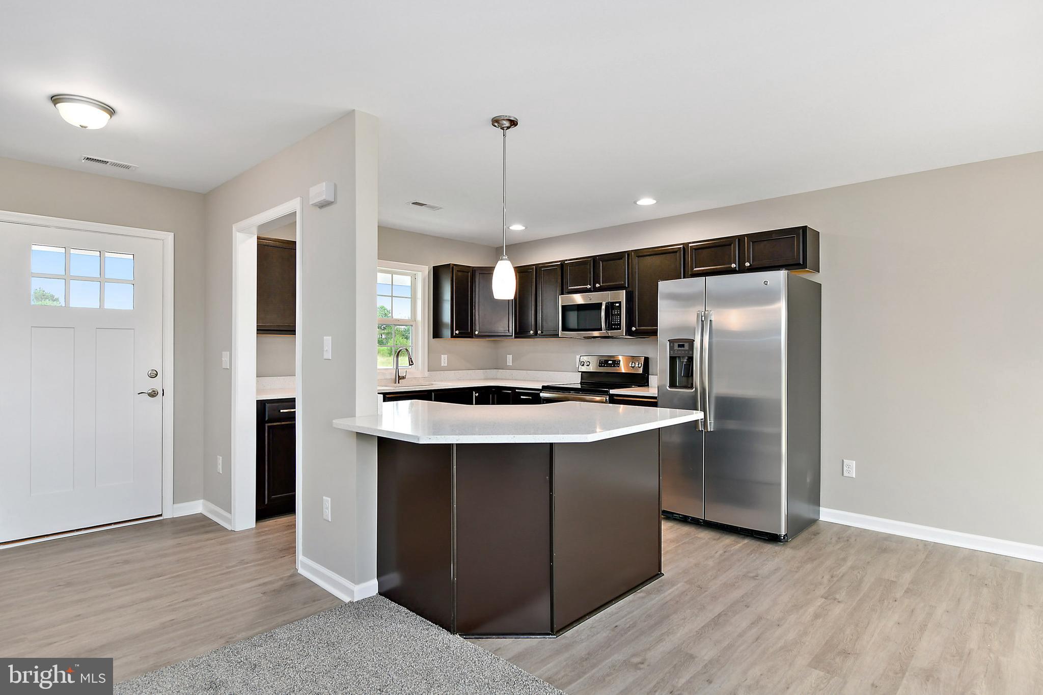 153 Fooks Road Bishopville, MD 21813 - Photo 8 of 30 a kitchen with stainless steel appliances a sink stove and refrigerator