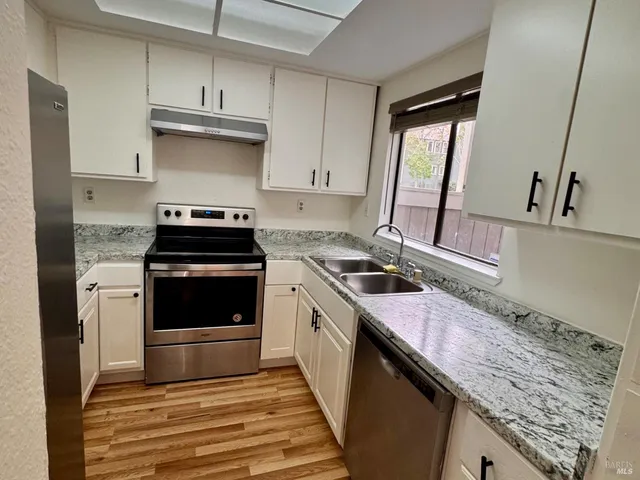 a kitchen with a stove and a sink
