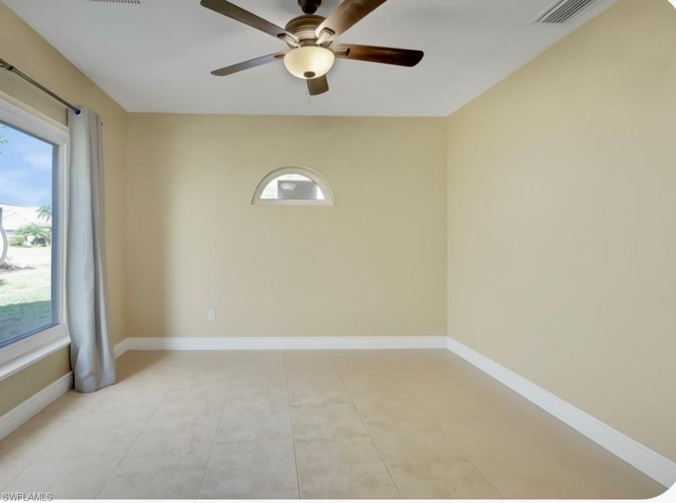 132 Johnnycake Drive Naples, FL 34110 - Photo 18 of 34 an empty room with a window and a fan