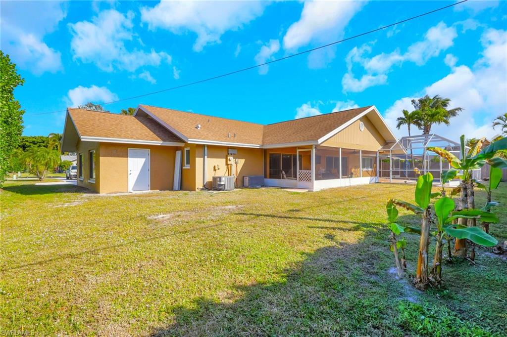 132 Johnnycake Drive Naples, FL 34110 - Photo 25 of 34 a front view of a house with a garden