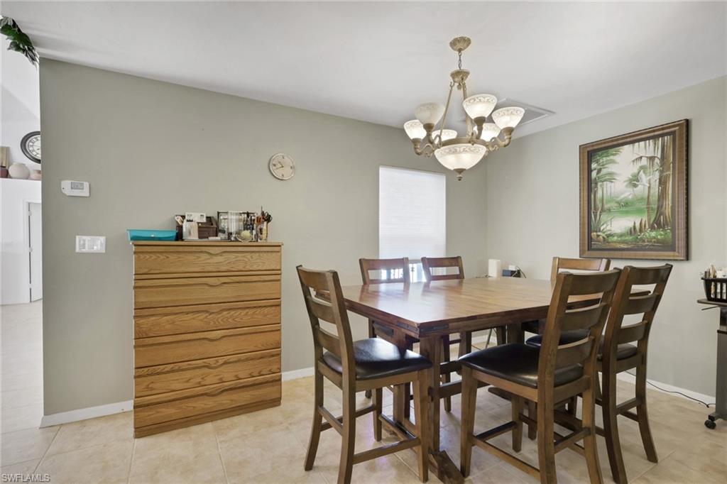 132 Johnnycake Drive Naples, FL 34110 - Photo 7 of 34 a view of a dining room with furniture and chandelier
