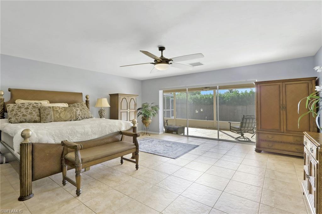 132 Johnnycake Drive Naples, FL 34110 - Photo 10 of 34 a living room with furniture and floor to ceiling window