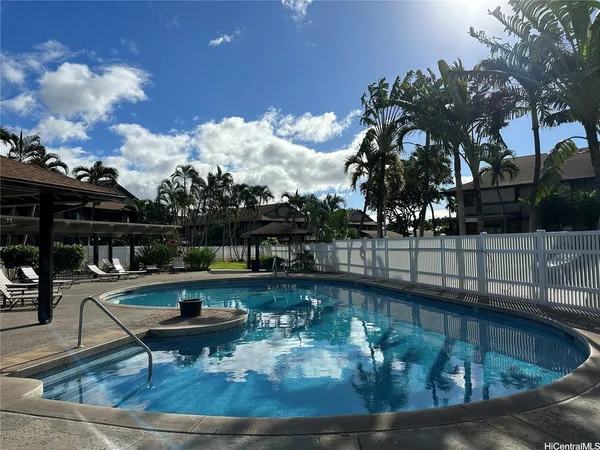 a view of a swimming pool with outdoor seating
