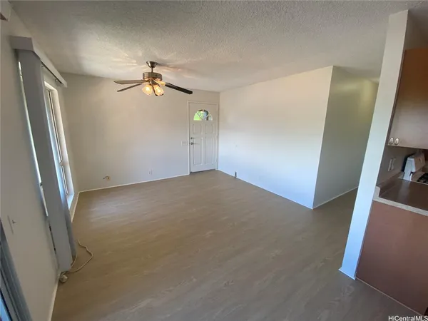 a kitchen with stainless steel appliances a refrigerator and wooden floor