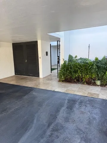 a view of an empty room with potted plants