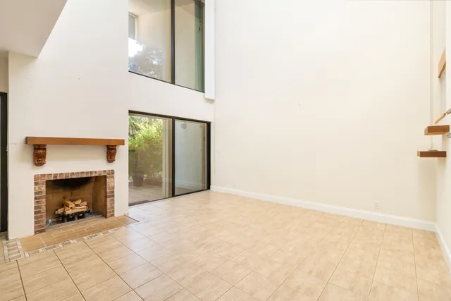 a view of an empty room with fire place