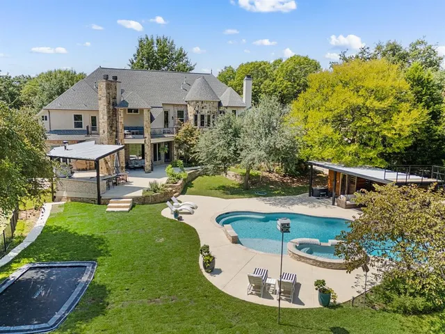 a swimming pool with outdoor seating and yard