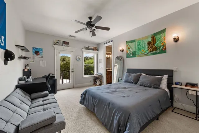 a bedroom with a large bed and a window