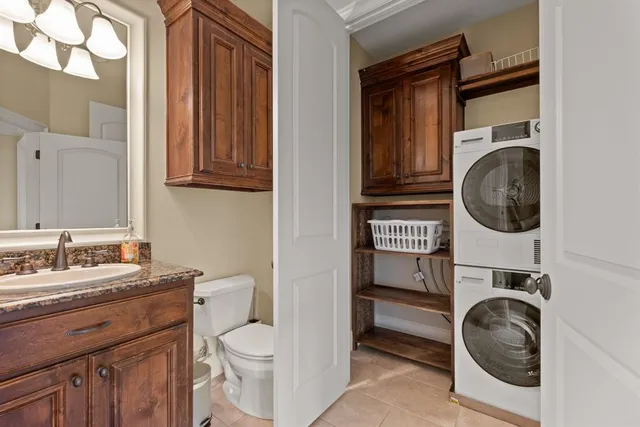 a utility room with sink dryer and washer