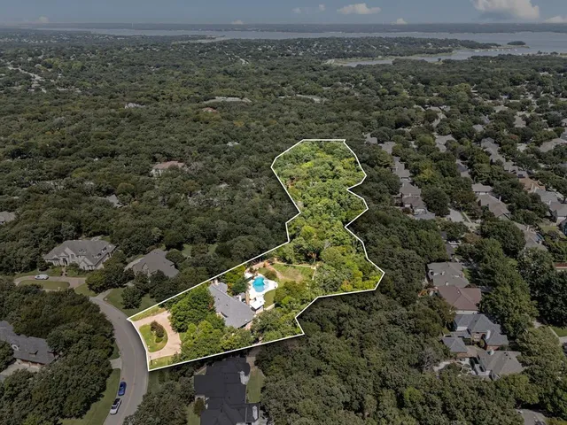 an aerial view of a house with a mountain