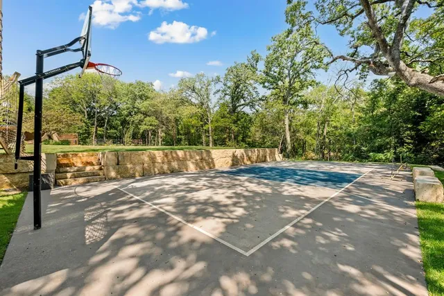 a view of a green field with wooden fence