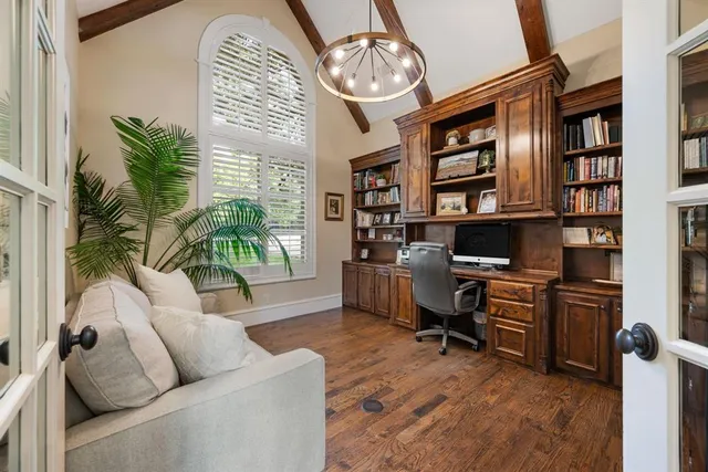 a view of a livingroom with workspace and a window