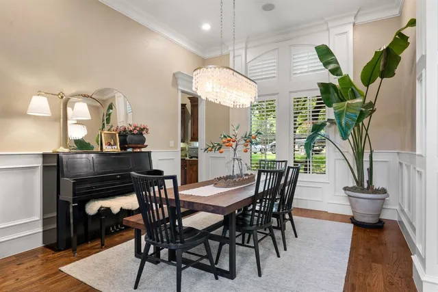 a view of a dining room with furniture and a potted plant