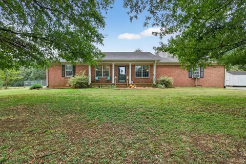 a front view of house with yard and green space