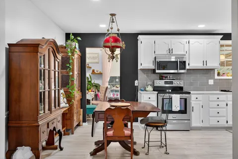 a kitchen with stainless steel appliances kitchen island granite countertop a refrigerator and microwave